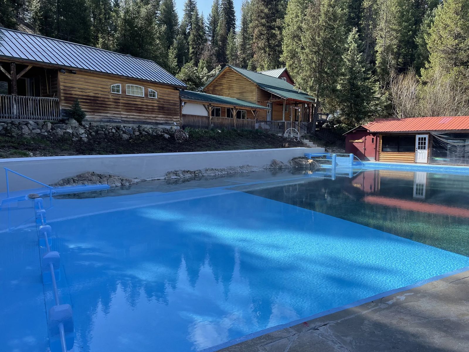 Geothermal pool with cabins behind